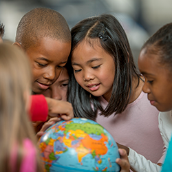 students in front of globe