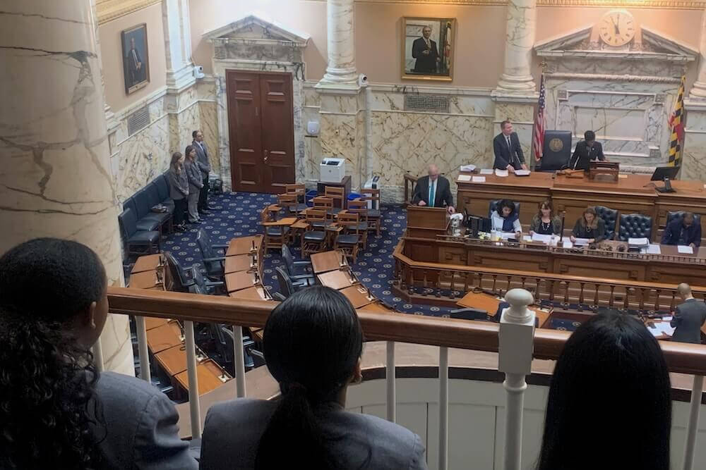 A group of Student Pages look from the balcony at other Pages serving in the Maryland State House