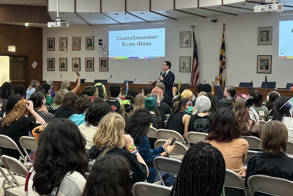Councilmember Evan Glass speaks to a group of students