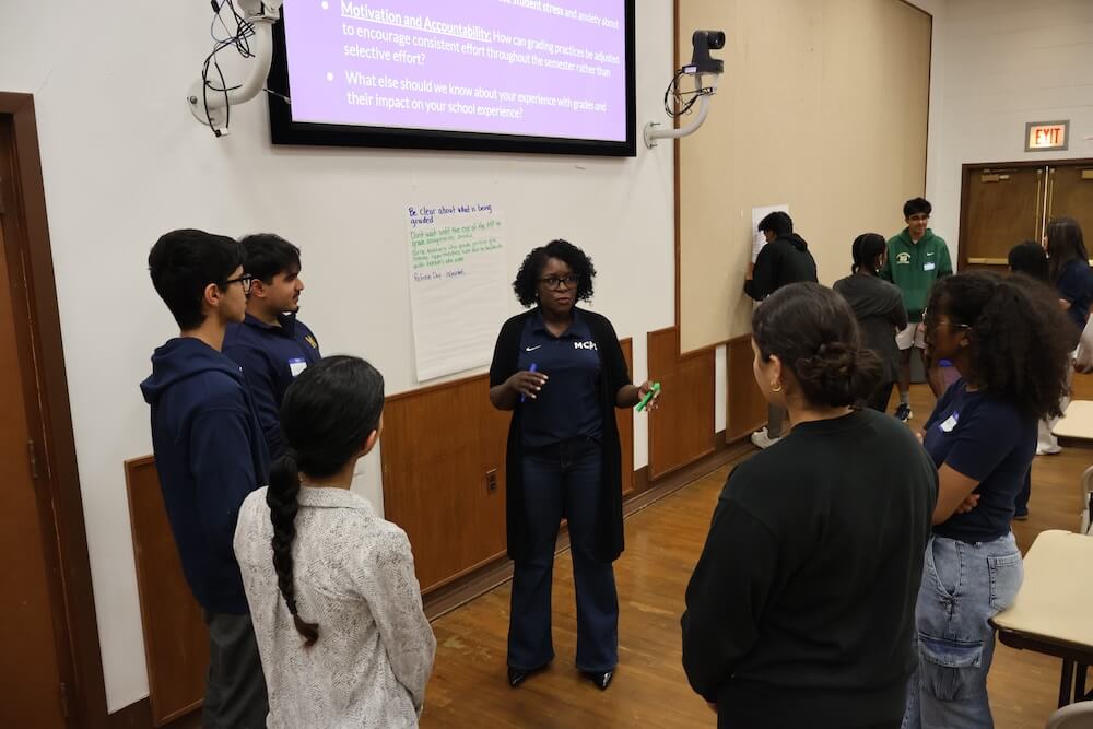 An MCPS Staff Member collaborates with a small group of students