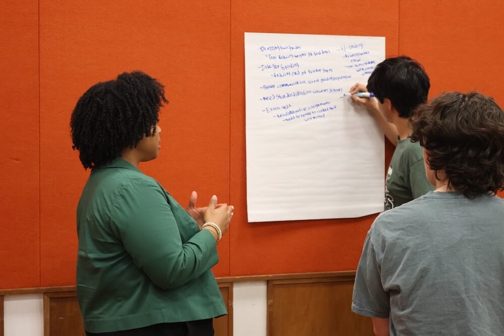 An MCPS Staff Member collaborates with a small group of students